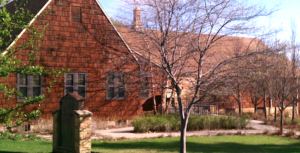 church building with lawn and trees